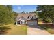 Charming two-story home with stone accents, a two-car garage, and a well-manicured lawn at 704 Williamsburg Ct, Villa Rica, GA 30180