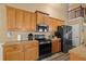 Kitchen featuring wood cabinetry and stainless steel appliances, offering a functional cooking space at 704 Williamsburg Ct, Villa Rica, GA 30180