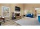 Spacious living room featuring a stone fireplace, large windows, and hardwood floors at 704 Williamsburg Ct, Villa Rica, GA 30180