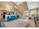 Open-concept living area with modern furniture, high ceilings, and staircase at 704 Williamsburg Ct, Villa Rica, GA 30180
