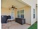 Covered patio with a ceiling fan, storage box, door and window at 704 Williamsburg Ct, Villa Rica, GA 30180