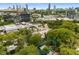 A lovely aerial shot of the neighborhood nestled amongst the trees with the city skyline in the background at 830 Belgrade Ne Ave, Atlanta, GA 30306
