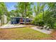 Backyard features include a fire pit, bocce ball court, deck, blue paint and lush greenery at 830 Belgrade Ne Ave, Atlanta, GA 30306
