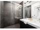Contemporary bathroom with double sinks, modern vanity, glass enclosed shower, and elegant tile work at 830 Belgrade Ne Ave, Atlanta, GA 30306