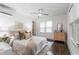 Sunlit bedroom featuring hardwood floors, a ceiling fan, and a chest of drawers by the window at 830 Belgrade Ne Ave, Atlanta, GA 30306