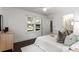 Bright bedroom features wood floors, ceiling fan, and a view to the outdoors through a window at 830 Belgrade Ne Ave, Atlanta, GA 30306