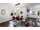 Chic dining room featuring hardwood floors, modern lighting fixture, and seamless flow into the updated kitchen at 830 Belgrade Ne Ave, Atlanta, GA 30306