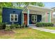 Charming blue bungalow with vibrant orange door and inviting covered front porch with rocking chairs at 830 Belgrade Ne Ave, Atlanta, GA 30306