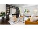 Sun-filled living room with hardwood floors, stylish furniture, and built-in shelving with decorative accents at 830 Belgrade Ne Ave, Atlanta, GA 30306