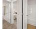 Hallway view of a full bathroom featuring a shower-tub combination and tile floors at 1344 Riverstone Rd # 108, Jonesboro, GA 30238