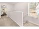 Hallway with carpeted floor, window with natural light, and view into bedroom at 1344 Riverstone Rd # 108, Jonesboro, GA 30238