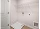 Bright laundry room featuring tile floor, utility sink, and washer/dryer hookups at 1344 Riverstone Rd # 108, Jonesboro, GA 30238