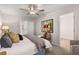 Bright and airy main bedroom with a ceiling fan, bench, and accent wall art at 1344 Riverstone Rd # 108, Jonesboro, GA 30238