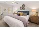 Bright main bedroom with ceiling fan, window, decorative pillows, and luxury finishes at 1344 Riverstone Rd # 108, Jonesboro, GA 30238