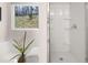 Bright bathroom featuring a shower and tub, next to a window with a nature view at 1344 Riverstone Rd # 108, Jonesboro, GA 30238