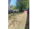 Expansive backyard with mature trees, green grass, a fence, and outdoor seating at 2044 Mallard Crest, Lithonia, GA 30058