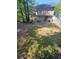 Large backyard with a patio area and mature trees, perfect for outdoor entertaining at 2044 Mallard Crest, Lithonia, GA 30058