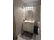 Small bathroom with a white vanity, mirror, and decorative light fixture at 2044 Mallard Crest, Lithonia, GA 30058