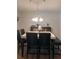 A cozy dining room features modern décor and a stylish chandelier for a unique entertaining space at 2044 Mallard Crest, Lithonia, GA 30058