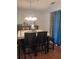 A cozy dining room with light-toned walls features modern decor and a stylish chandelier and light hardwood floors at 2044 Mallard Crest, Lithonia, GA 30058
