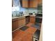 A functional kitchen with stainless steel appliances and wood cabinets provides a comfortable cooking space at 2044 Mallard Crest, Lithonia, GA 30058
