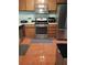 Functional kitchen with stainless steel appliances, tiled flooring and wood cabinets provides a comfortable cooking space at 2044 Mallard Crest, Lithonia, GA 30058