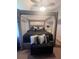 The main bedroom features a bed frame with a large padded headboard, and ceiling fan at 2044 Mallard Crest, Lithonia, GA 30058