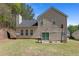 Large backyard with a patio, grill, and basketball hoop at 395 Anvil Way, Austell, GA 30168