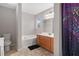 Bathroom featuring a soaking tub, single sink vanity, and a colorful shower curtain at 395 Anvil Way, Austell, GA 30168