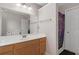 Bathroom featuring a single sink vanity, and a shower with a colorful shower curtain at 395 Anvil Way, Austell, GA 30168