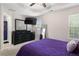 Bedroom with black furniture, recessed ceiling, TV, and ensuite bathroom at 395 Anvil Way, Austell, GA 30168