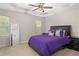 Spacious bedroom with a tray ceiling, plush carpet and furnishings with a purple theme at 395 Anvil Way, Austell, GA 30168