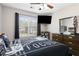 Bedroom featuring a ceiling fan, TV, dresser, and a window that provides natural light at 395 Anvil Way, Austell, GA 30168