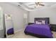 Bedroom with large mirror, ceiling fan and purple bedding at 395 Anvil Way, Austell, GA 30168