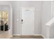 Bright entryway with a white front door, hardwood floors, and a view into a naturally lit room at 395 Anvil Way, Austell, GA 30168