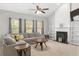 Inviting living room showcasing a cozy sectional, stylish decor, and a fireplace with decorative shelving at 395 Anvil Way, Austell, GA 30168