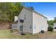 Exterior rear view showing siding, a basketball hoop, trees, and a grill set against a bright blue sky at 395 Anvil Way, Austell, GA 30168