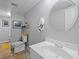 Neutral bathroom featuring a round mirror, white vanity with sink, toilet, and a peek into the shower at 4016 Upland Trce, Marietta, GA 30066