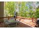 An inviting deck with a glass-top table and chairs, perfect for outdoor dining and relaxation amidst lush greenery at 4016 Upland Trce, Marietta, GA 30066