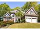 Charming two-story home boasts a well-manicured lawn, two-car garage, and inviting curb appeal at 4016 Upland Trce, Marietta, GA 30066