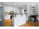 Bright kitchen featuring white cabinets, stainless steel appliances, and a functional center island with a dark countertop at 4016 Upland Trce, Marietta, GA 30066