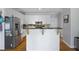 Well-lit kitchen showcasing white cabinetry, stainless steel refrigerator, island with dark counter, and hardwood floors at 4016 Upland Trce, Marietta, GA 30066