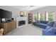 Cozy living room featuring a fireplace, plush seating, and natural light at 4016 Upland Trce, Marietta, GA 30066
