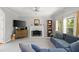 Cozy living room featuring a fireplace, plush seating, and natural light at 4016 Upland Trce, Marietta, GA 30066