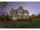 Beautiful two-story home with a landscaped backyard, deck, and covered patio area at 895 Ovalene Sw Ln, Marietta, GA 30064