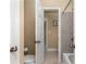 Bathroom with white door, beige walls, and brown tile, creating a clean and practical space at 895 Ovalene Sw Ln, Marietta, GA 30064