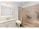 Accessible bathroom featuring a walk-in shower, tiled walls, and single vanity at 895 Ovalene Sw Ln, Marietta, GA 30064