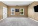 Spacious bedroom with neutral carpeting, a large window, and modern fixtures at 895 Ovalene Sw Ln, Marietta, GA 30064