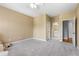 Spacious bedroom featuring soft carpet and a view to the bathroom, creating a tranquil and inviting atmosphere at 895 Ovalene Sw Ln, Marietta, GA 30064