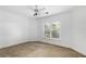 Bedroom with neutral carpet, white walls, and large window at 895 Ovalene Sw Ln, Marietta, GA 30064
